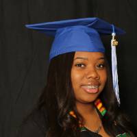 student takes a picture at the photobooth for GradFest